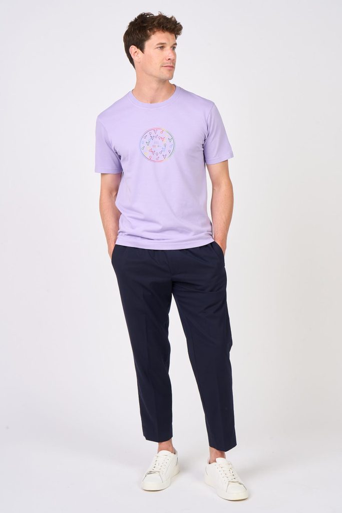 Lilac T-shirt with multicoloured All Equal motif in the name of an inclusive society, worn by male model with navy trousers